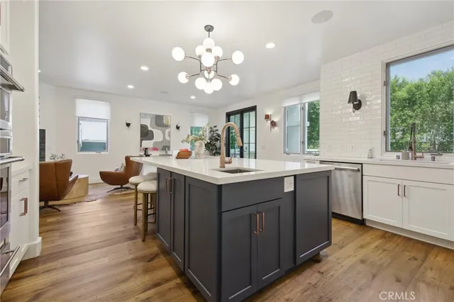 a kitchen with a sink stove and wooden cabinets