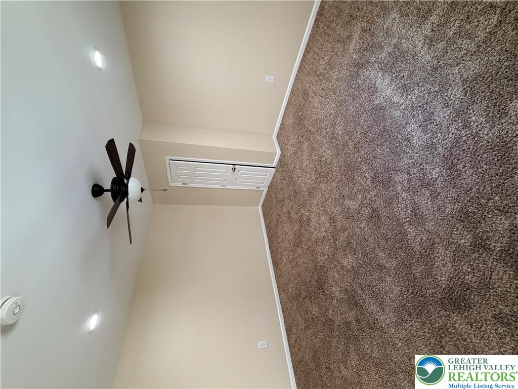 718 Ferry Street Easton, PA 18042 - Photo 16 of 37 An inviting room features plush carpet and an overhead ceiling fan for comfort.