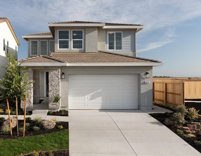 4424 Canyon Coral Way Rancho Cordova, CA 95742 - Photo 1 of 12 a front view of a house with garden