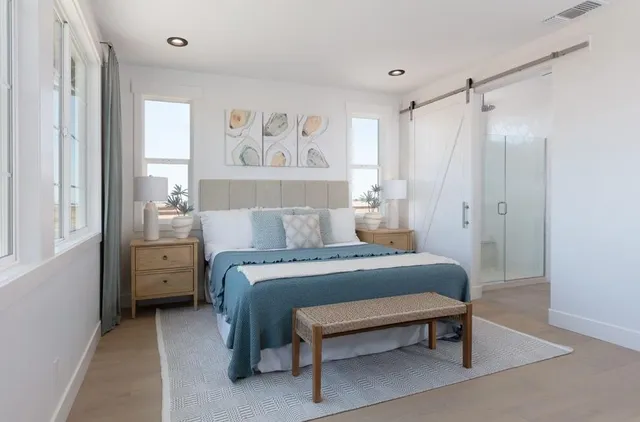 a bedroom with a bed and a painting on the wall