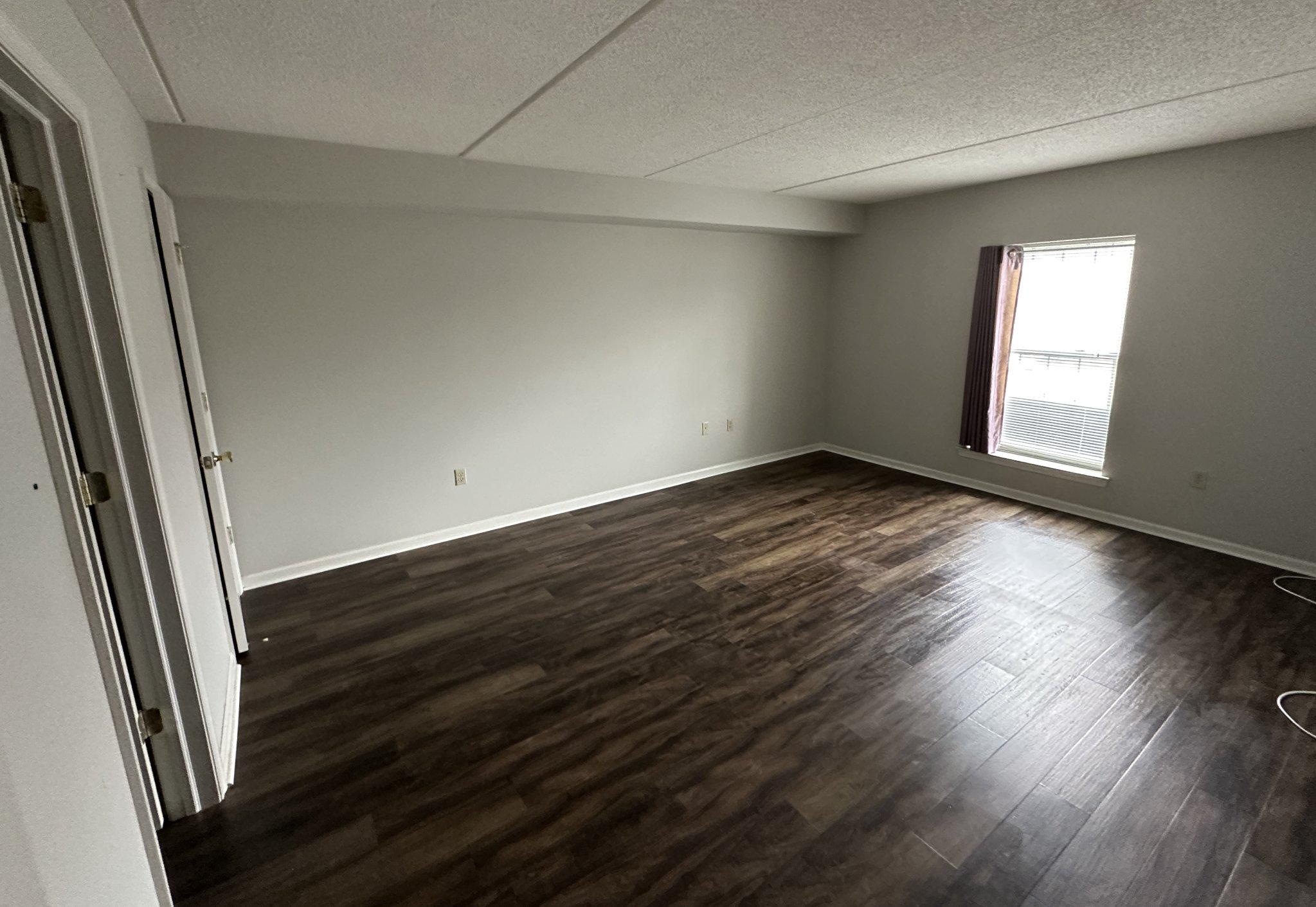 613 Brandon Road Norristown, PA 19403 - Photo 17 of 22 an empty room with wooden floor and windows