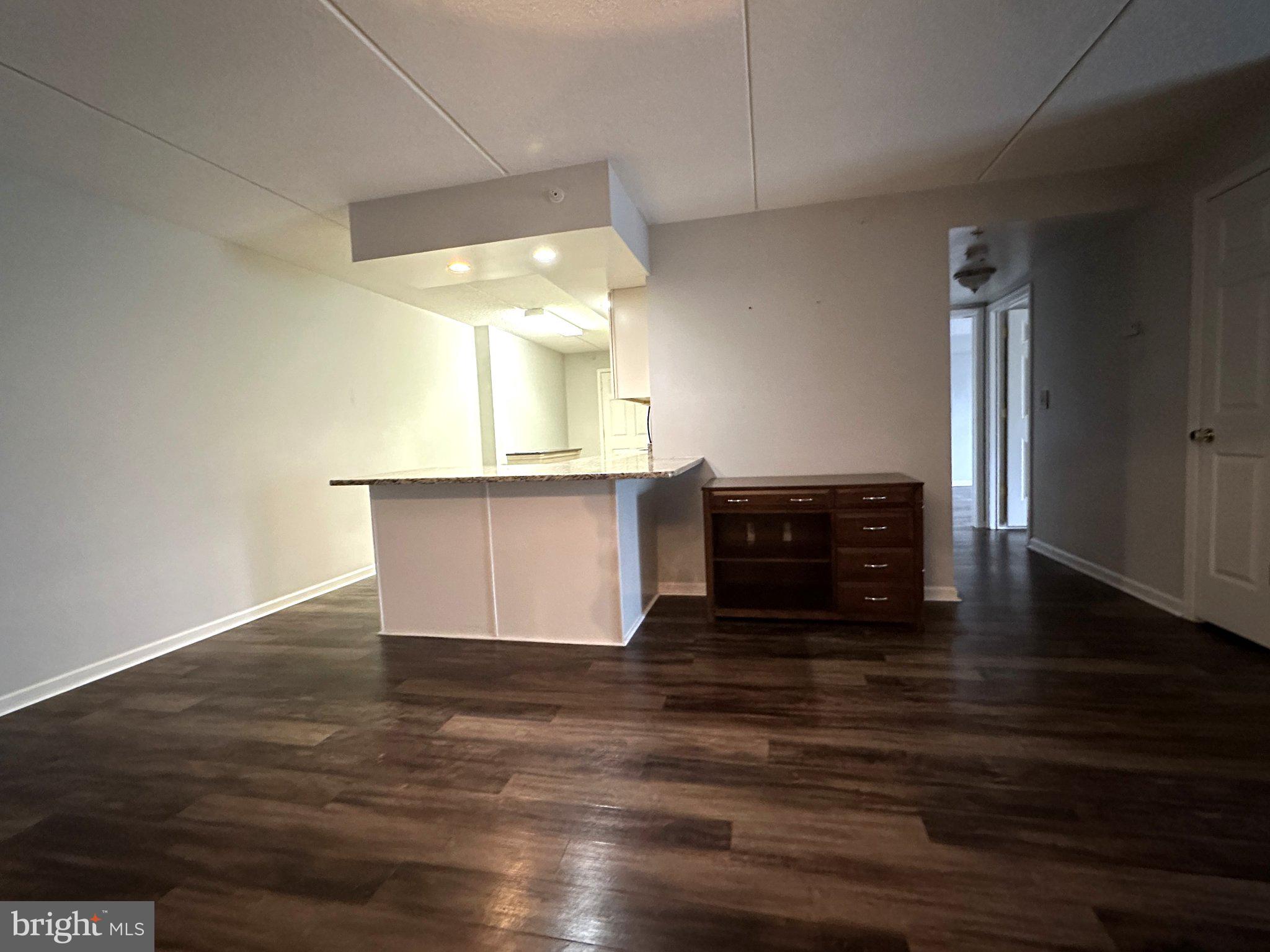 613 Brandon Road Norristown, PA 19403 - Photo 7 of 22 a view of kitchen and empty room with wooden floor