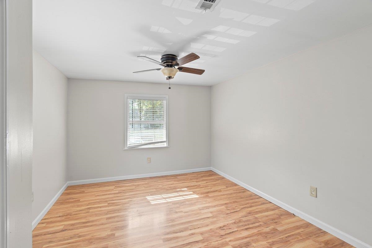 1886 Danville Road Memphis, TN 38117 - Photo 12 of 23 a view of empty room with wooden floor and fan