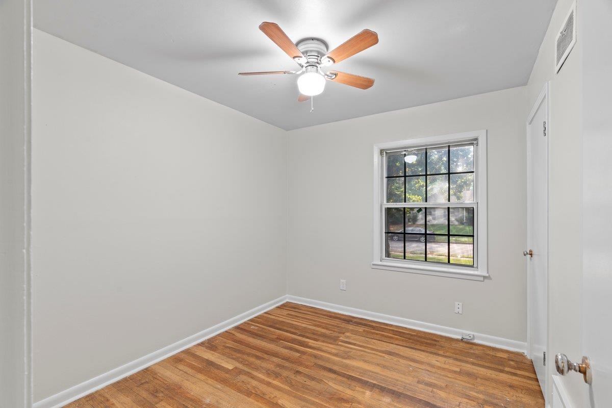 1886 Danville Road Memphis, TN 38117 - Photo 14 of 23 an empty room with window and ceiling fan