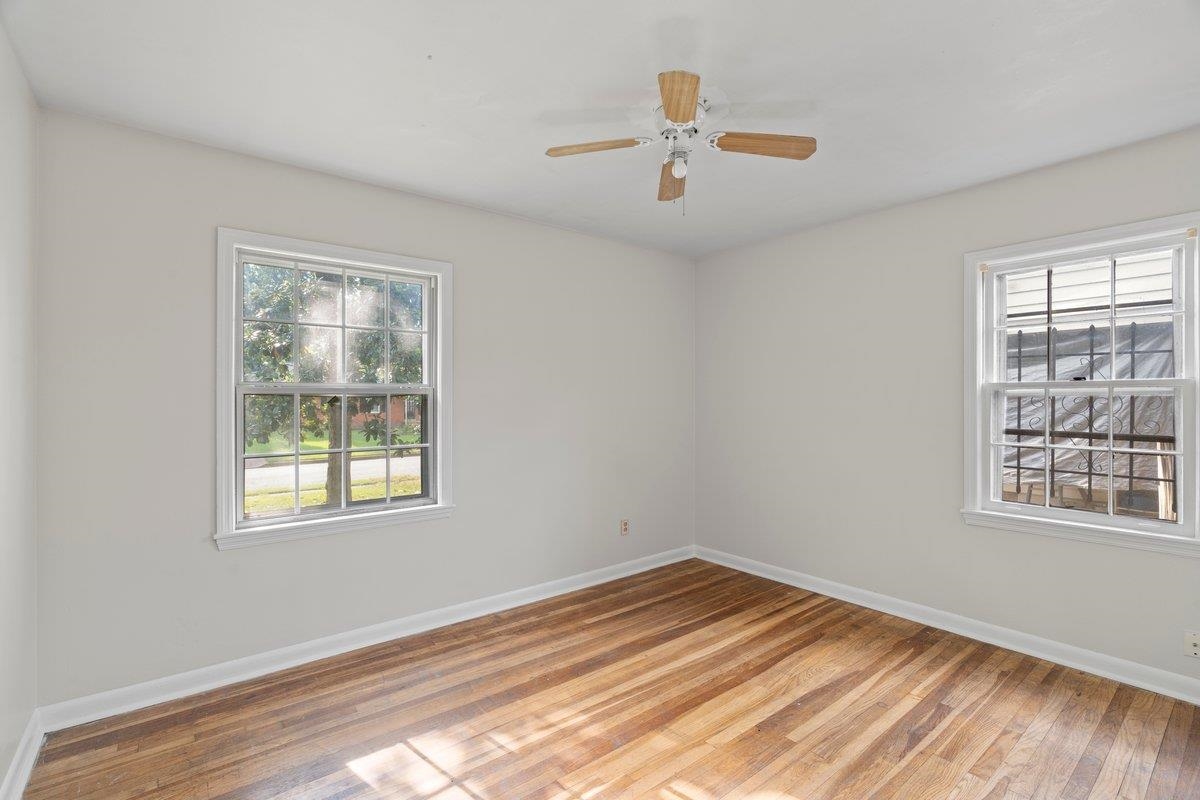1886 Danville Road Memphis, TN 38117 - Photo 16 of 23 a view of an empty room with wooden floor and a window