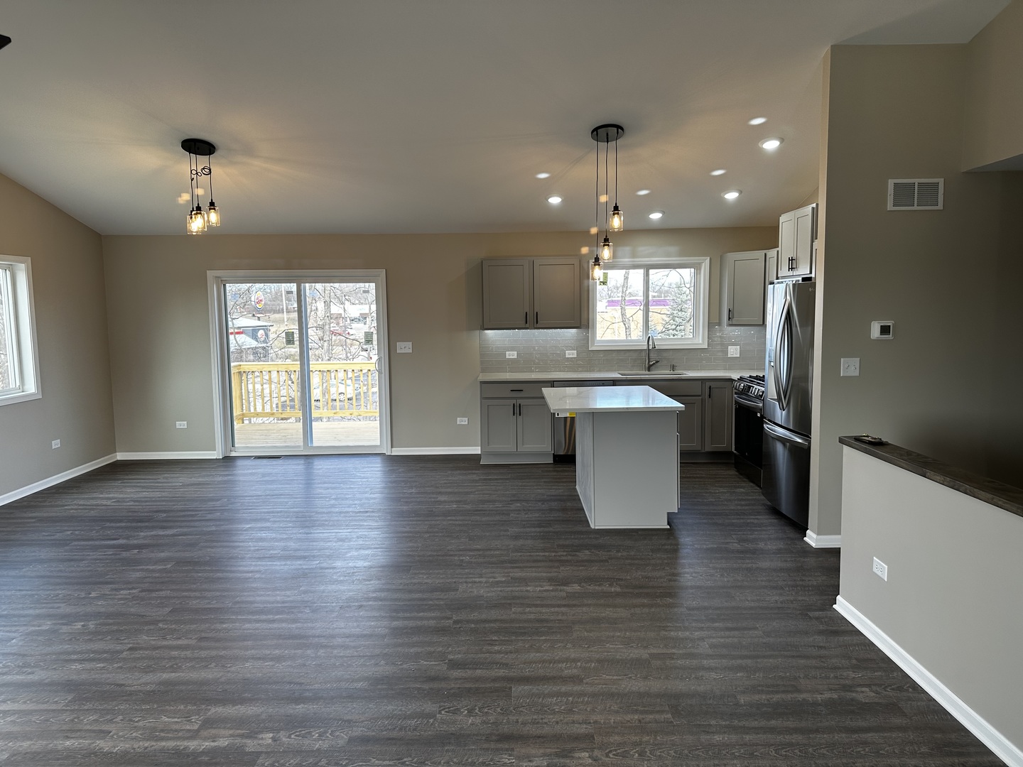 317 Buena Terrace Antioch, IL 60002 - Photo 2 of 10 an open kitchen with kitchen island white cabinets and stainless steel appliances