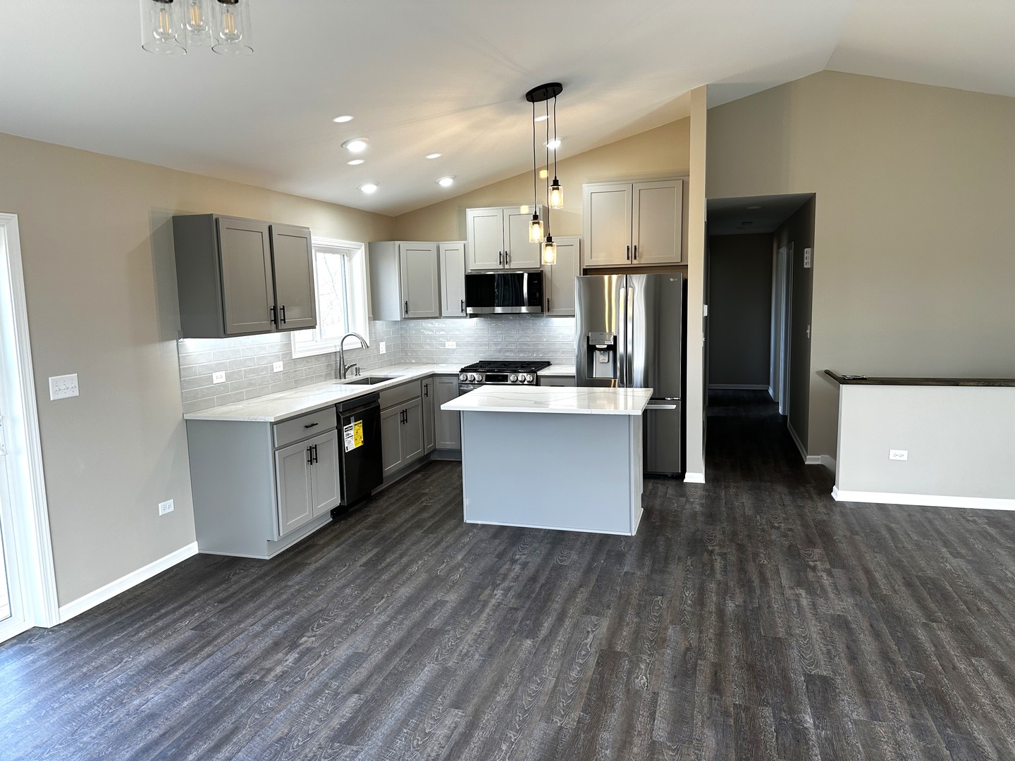 317 Buena Terrace Antioch, IL 60002 - Photo 7 of 10 a kitchen with stainless steel appliances a kitchen island hardwood floor sink stove and wooden cabinets