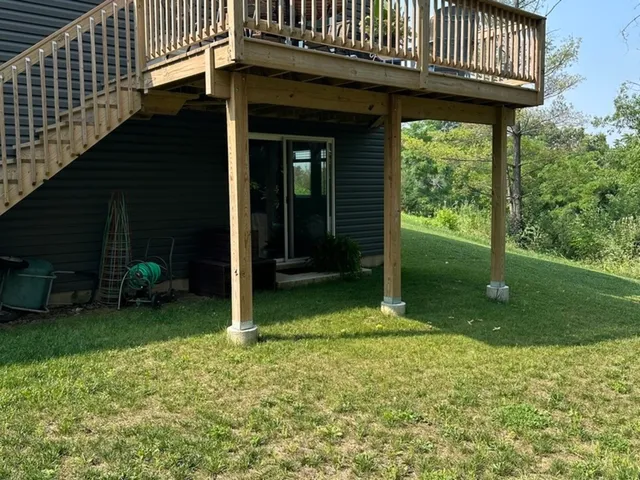 a view of a house with backyard porch and sitting area