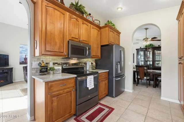 a kitchen with stainless steel appliances granite countertop a refrigerator a stove top oven a sink and dishwasher
