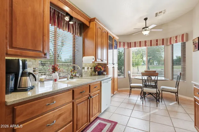 a kitchen with granite countertop a sink and cabinets