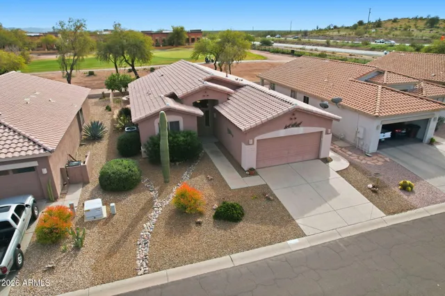 an aerial view of a house with a garden and lake view
