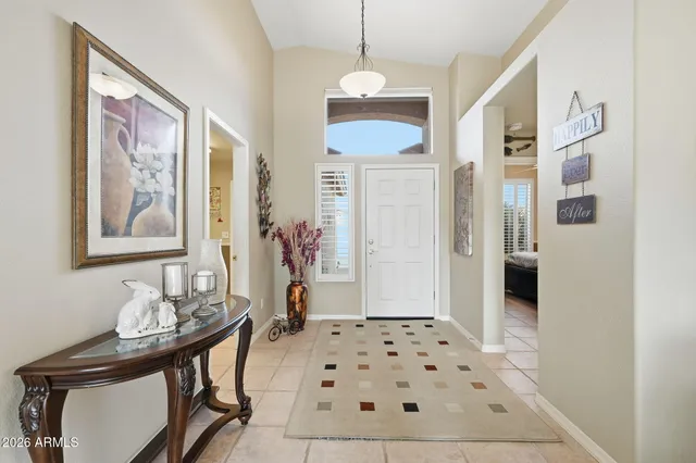 a view of a hallway with furniture and chandelier