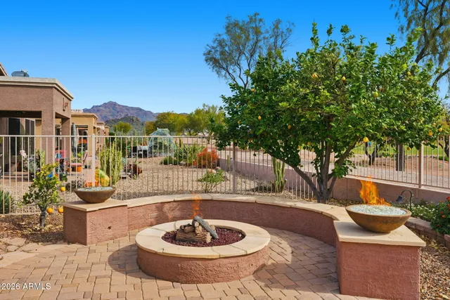 a view of a patio with couches table and chairs and potted plants