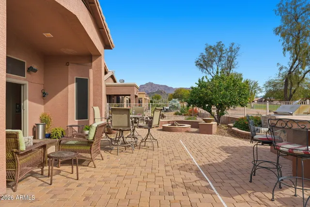 a view of a patio with couches table and chairs and potted plants