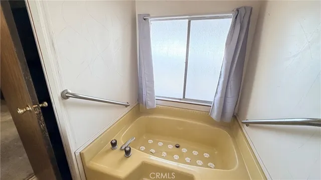 a view of a balcony with two chairs and a table