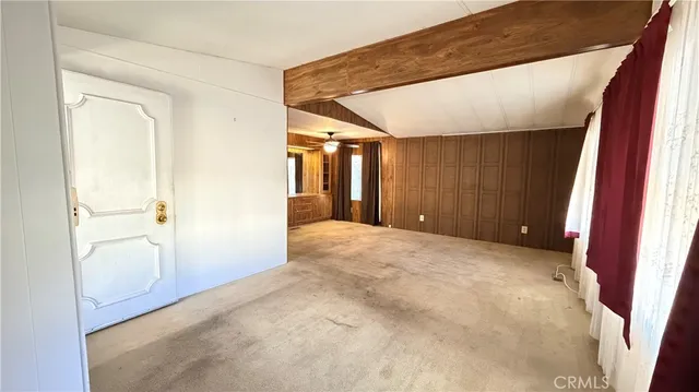 a view of an empty room with wooden walls