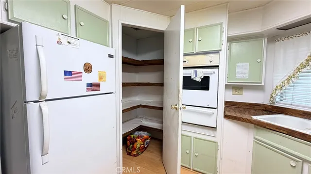 a kitchen with a stove and a refrigerator