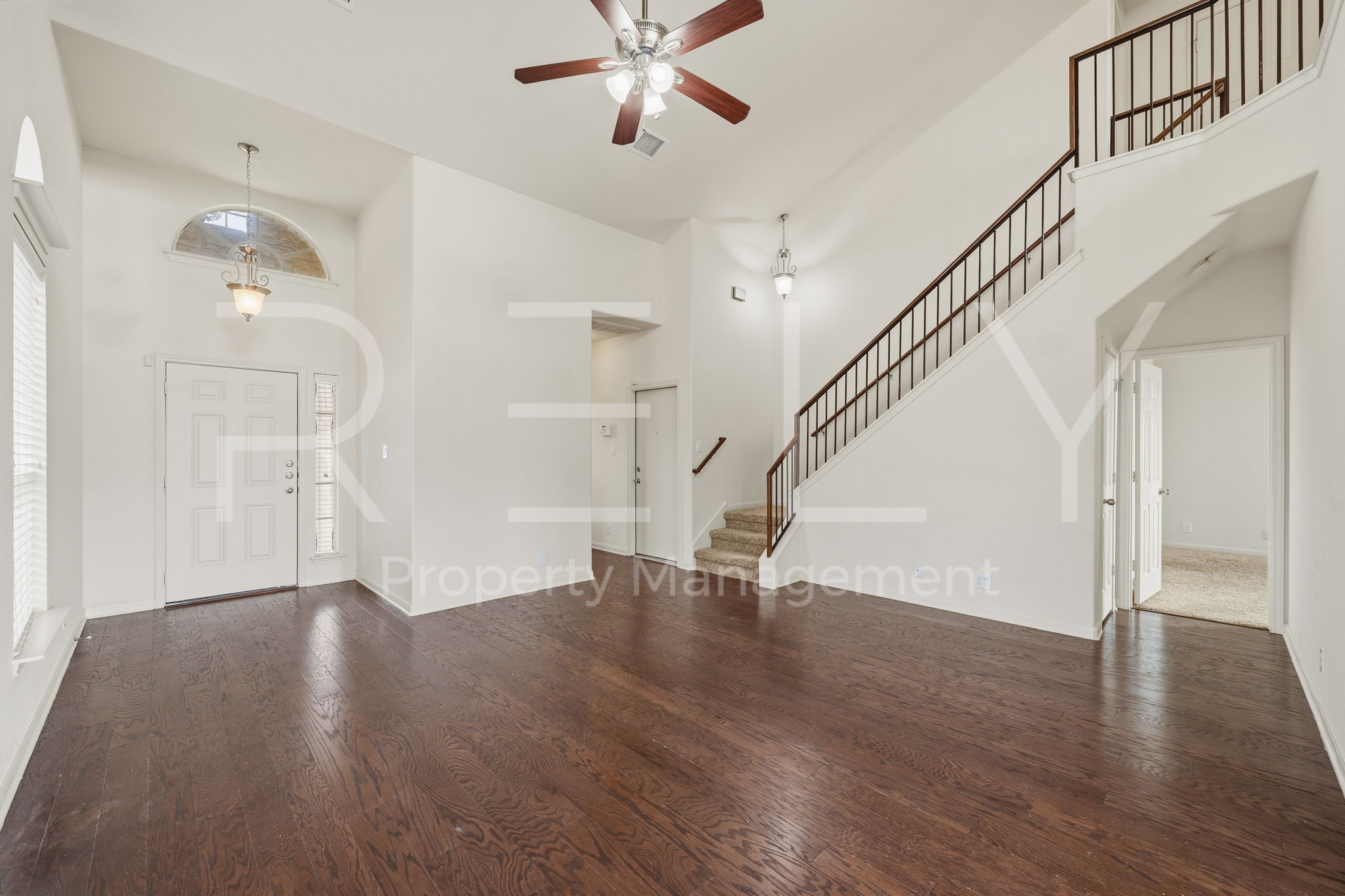 1405 Sunny Meadows Loop Georgetown, TX 78626 - Photo 6 of 40 A spacious entry area with rich hardwood floors welcomes you to this high-ceilinged home, featuring a prominent staircase leading to the upper level.