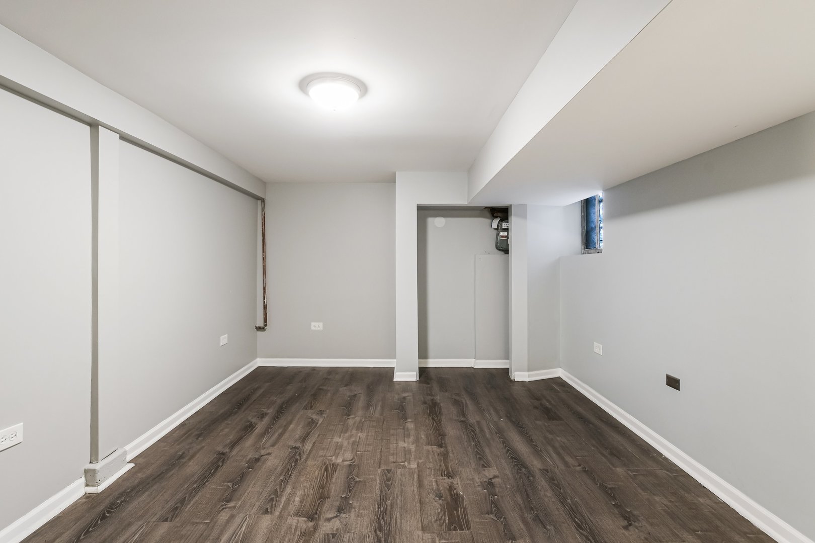 1523 East 85th Street Chicago, IL 60619 - Photo 17 of 27 an empty room with wooden floor and windows