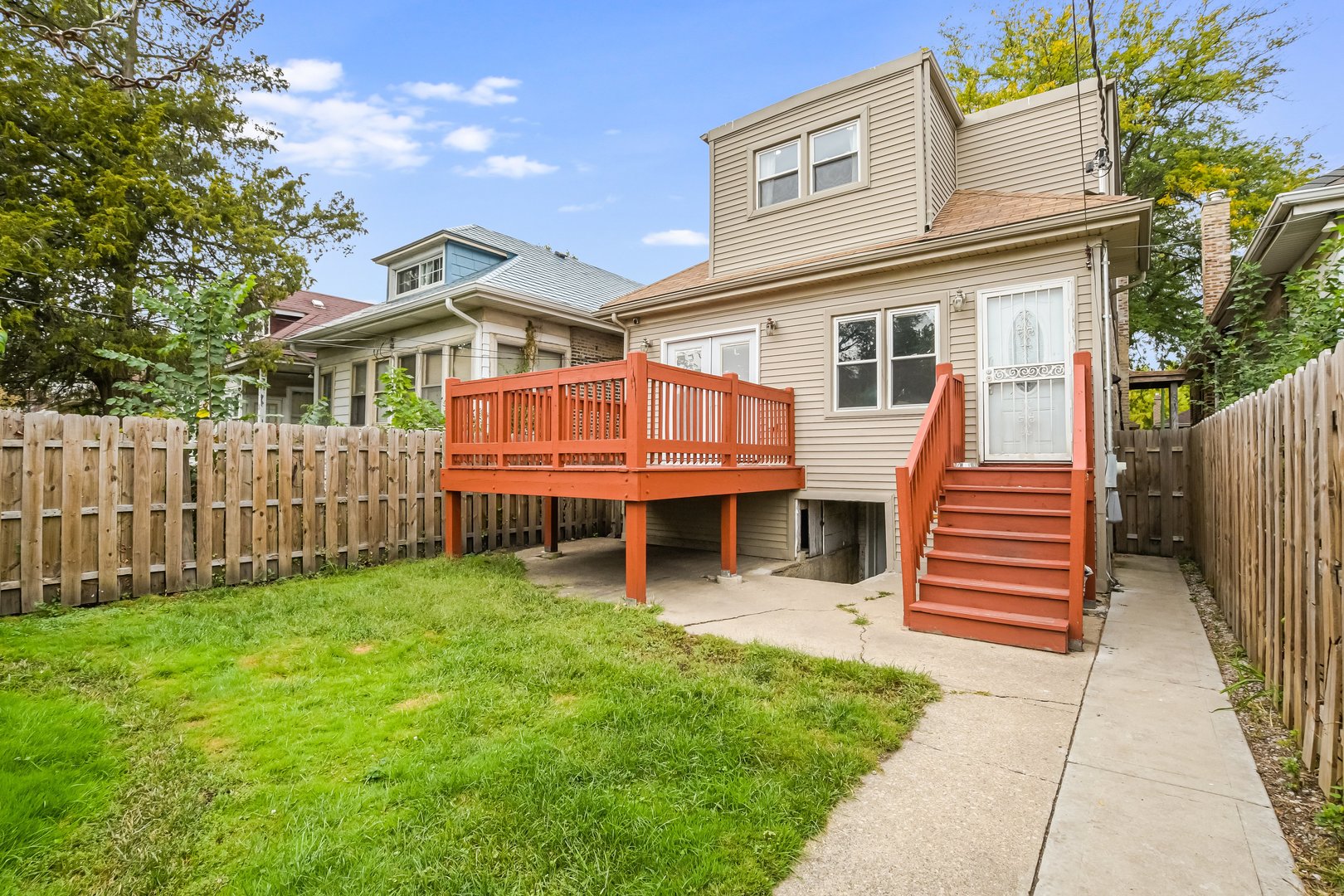 1523 East 85th Street Chicago, IL 60619 - Photo 22 of 27 a view of a house with a yard and wooden fence