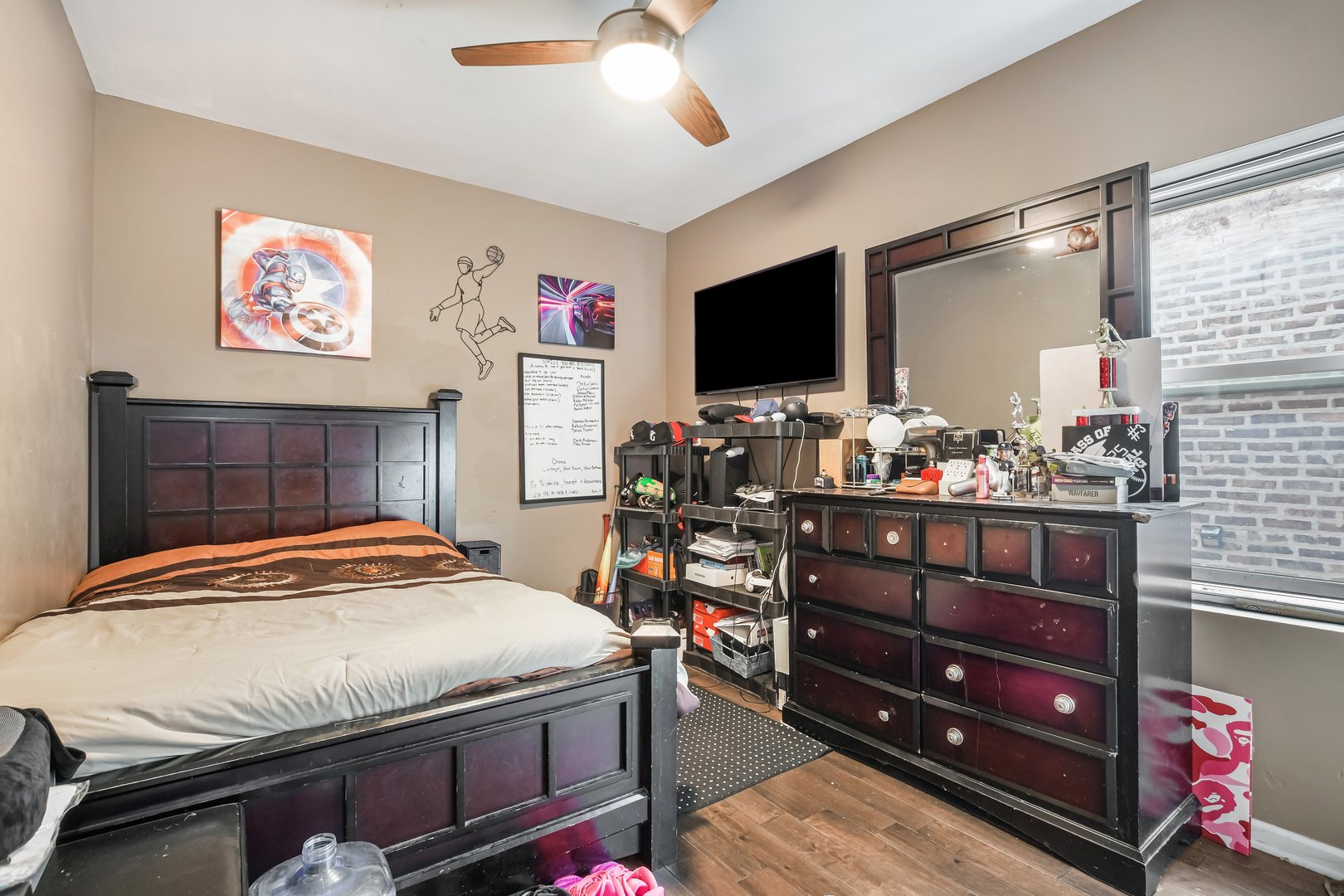 1523 East 85th Street Chicago, IL 60619 - Photo 8 of 27 a bedroom with bed and flat screen tv