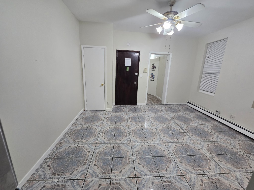 750 Glenmore Avenue, Unit 1 Brooklyn, NY 11208 - Photo 2 of 6 wooden floor in an empty room with a window