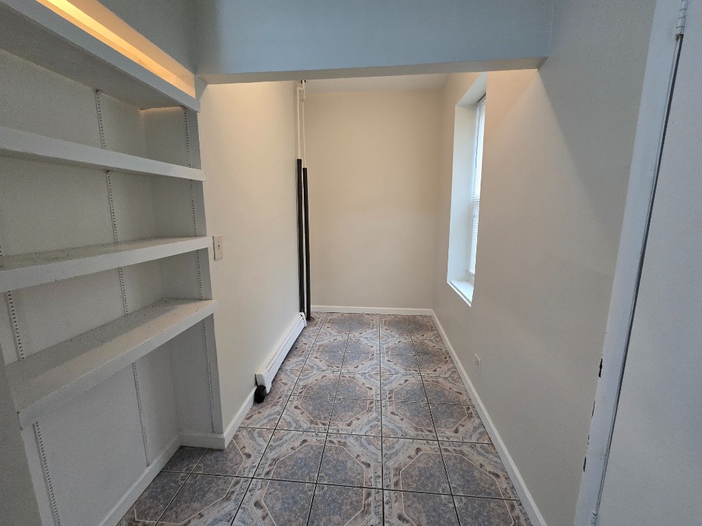 750 Glenmore Avenue, Unit 1 Brooklyn, NY 11208 - Photo 5 of 6 a view of a room with shelf