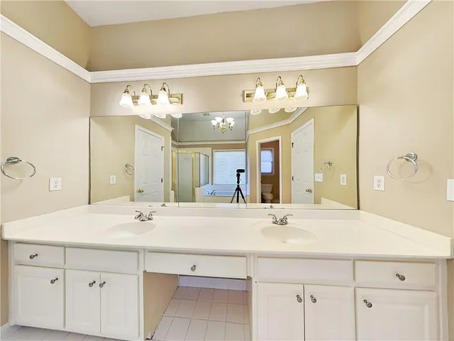 a bathroom with a sink double vanity and a mirror