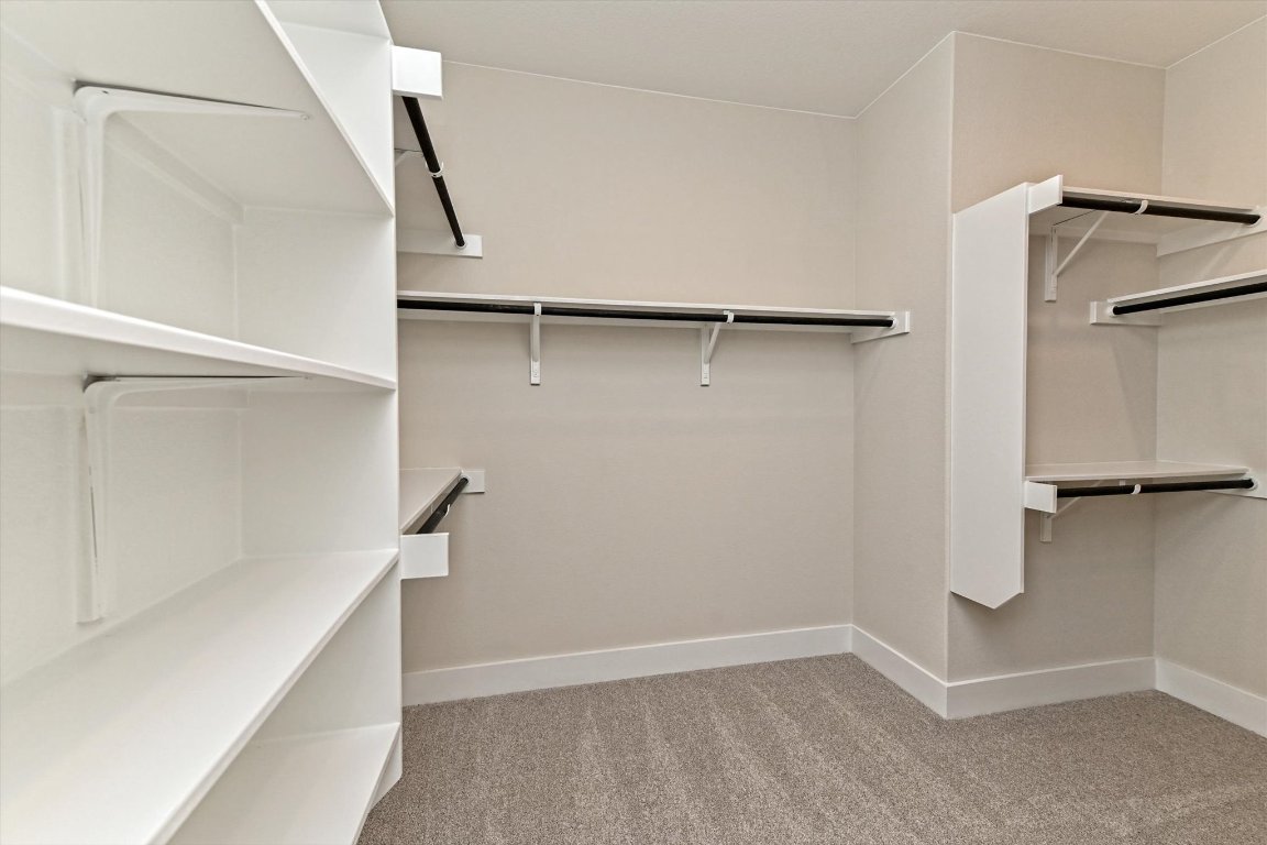 1221 Stormy Drive Georgetown, TX 78628 - Photo 19 of 33 a view of walk in closet with empty racks