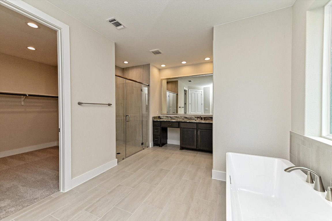 1221 Stormy Drive Georgetown, TX 78628 - Photo 21 of 33 a bathroom with a tub sink shower and mirror
