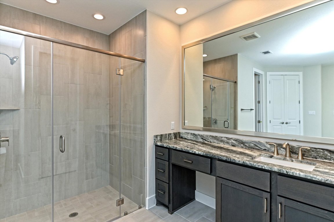 1221 Stormy Drive Georgetown, TX 78628 - Photo 23 of 33 a bathroom with a granite countertop sink mirror and double