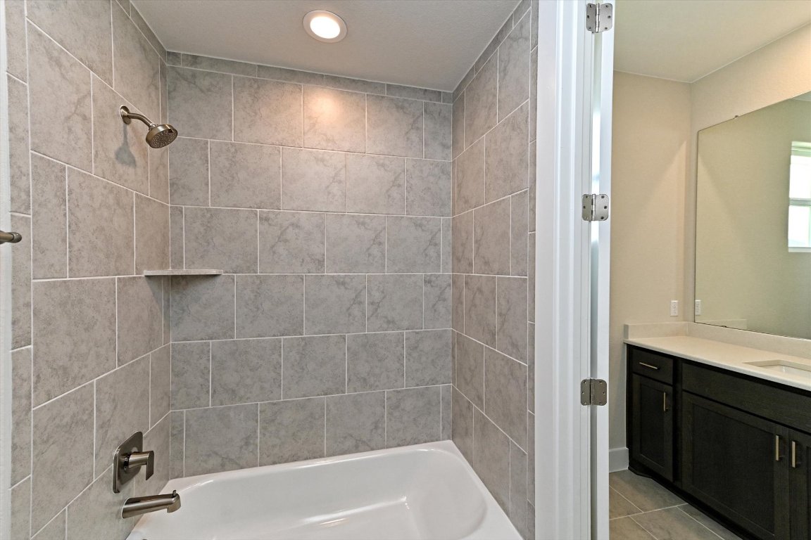 1221 Stormy Drive Georgetown, TX 78628 - Photo 25 of 33 a bathroom with a shower and a sink