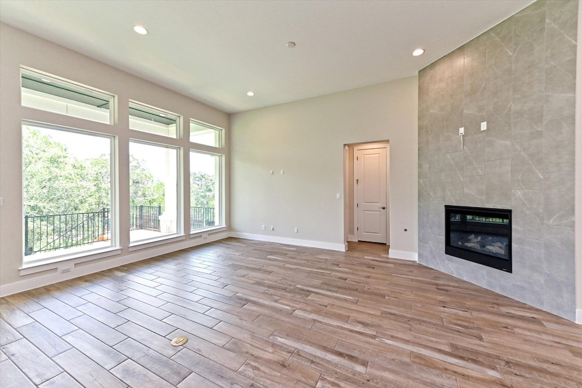 1221 Stormy Drive Georgetown, TX 78628 - Photo 6 of 33 a view of empty room with wooden floor and fireplace