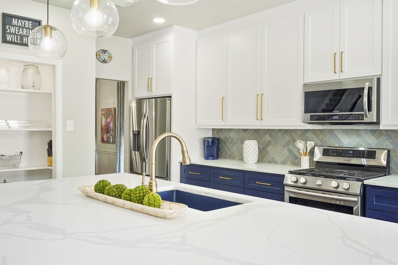 8615 Discus Drive Humble, TX 77346 - Photo 13 of 50 a kitchen with stainless steel appliances granite countertop a stove a sink and a microwave