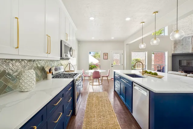 a kitchen with lots of counter space and wooden floor