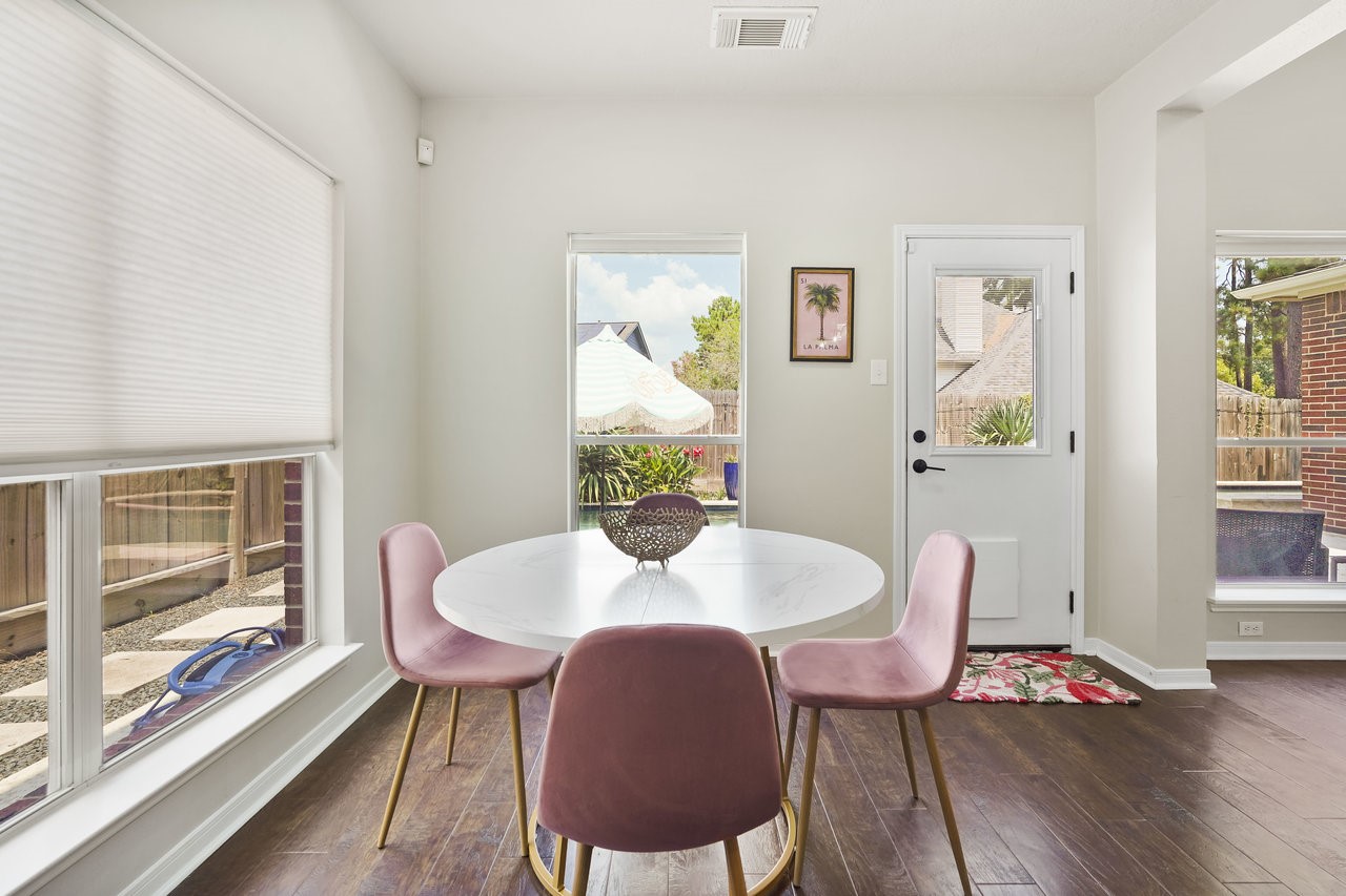8615 Discus Drive Humble, TX 77346 - Photo 16 of 50 a view of a dining room with furniture wooden floor and a potted plant