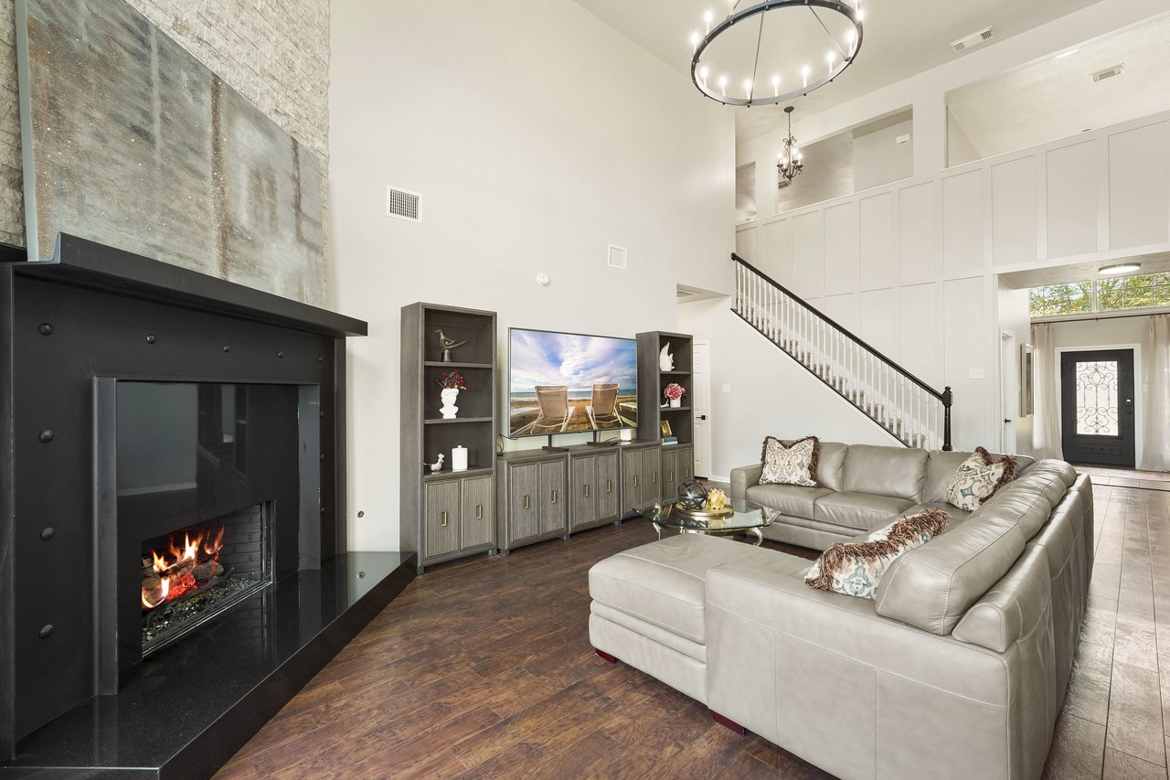 8615 Discus Drive Humble, TX 77346 - Photo 18 of 50 a living room with furniture a flat screen tv and a fireplace