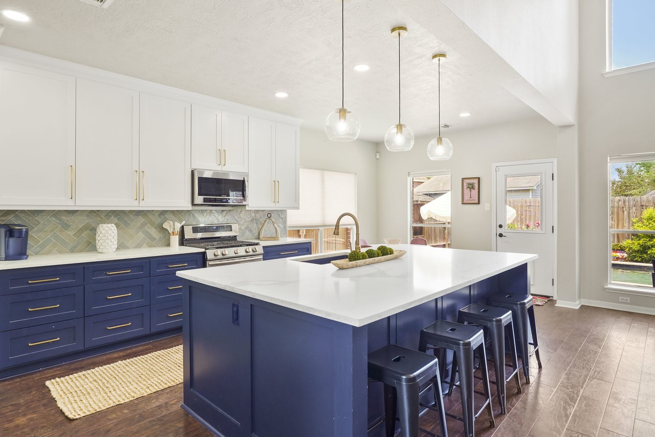 8615 Discus Drive Humble, TX 77346 - Photo 2 of 50 a kitchen with a stove a sink a dining table and chairs