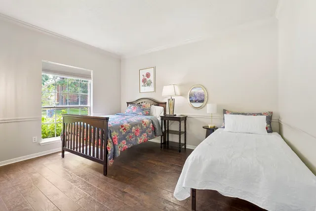 a bedroom with two beds and a window