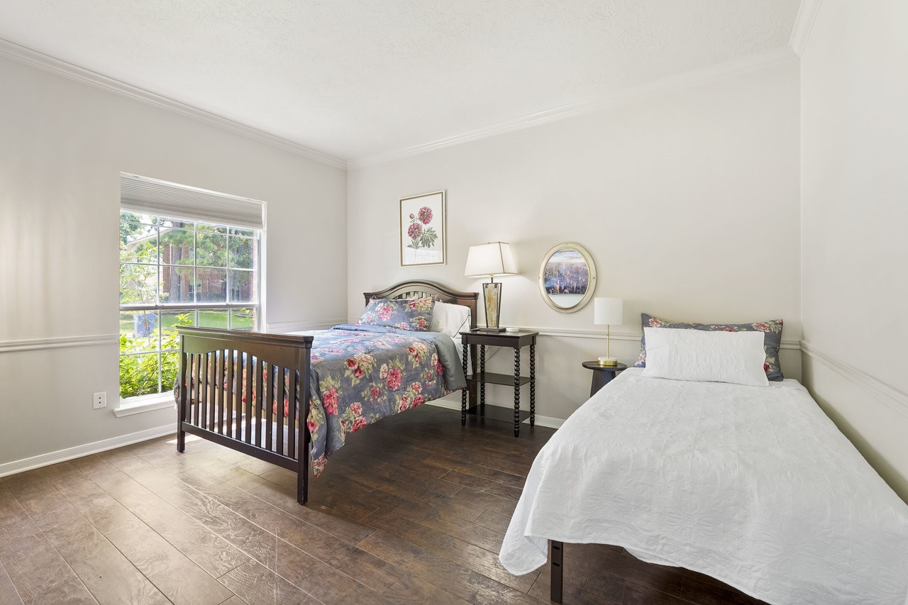 8615 Discus Drive Humble, TX 77346 - Photo 25 of 50 a bedroom with two beds and a window