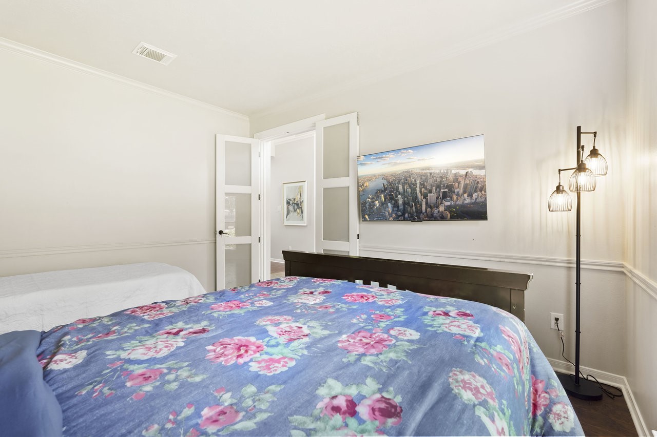 8615 Discus Drive Humble, TX 77346 - Photo 26 of 50 a bedroom with a bed and a painting on the wall