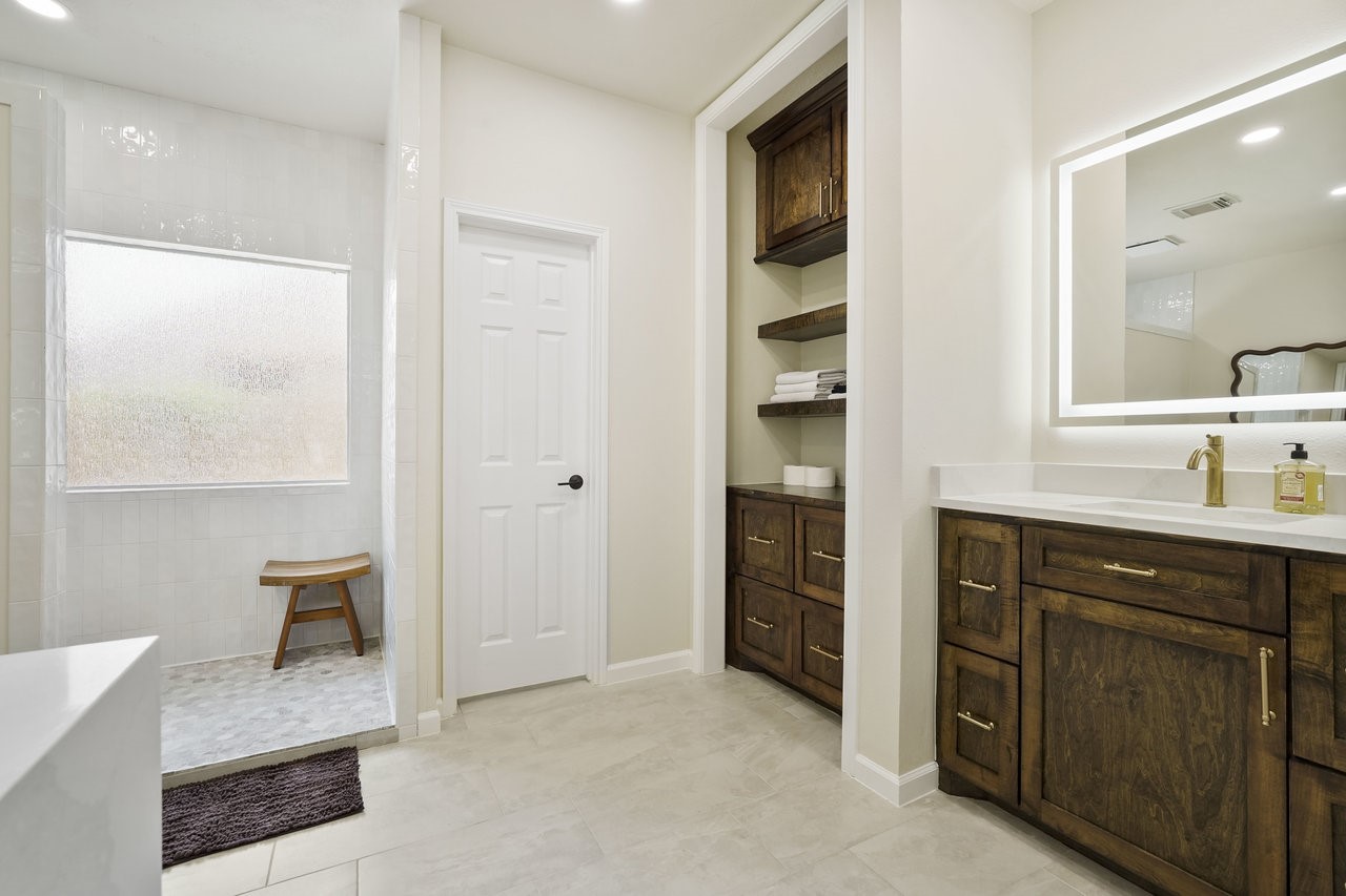 8615 Discus Drive Humble, TX 77346 - Photo 29 of 50 a spacious bathroom with a double vanity sink a and a mirror
