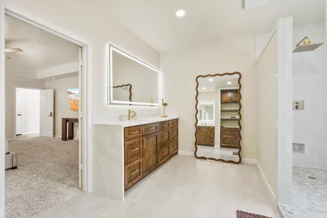 a spacious bathroom with a double vanity sink a and a mirror