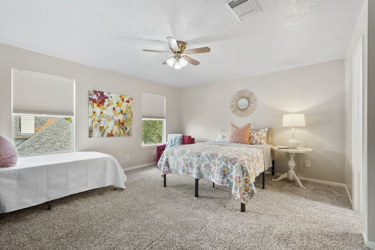 8615 Discus Drive Humble, TX 77346 - Photo 34 of 50 a bed room with a bed and a couch