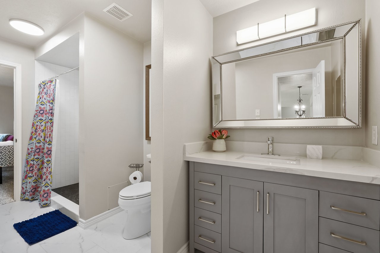 8615 Discus Drive Humble, TX 77346 - Photo 36 of 50 a bathroom with a toilet a sink and a mirror