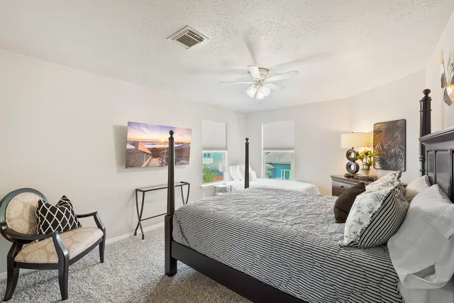 a bedroom with a bed and a chair