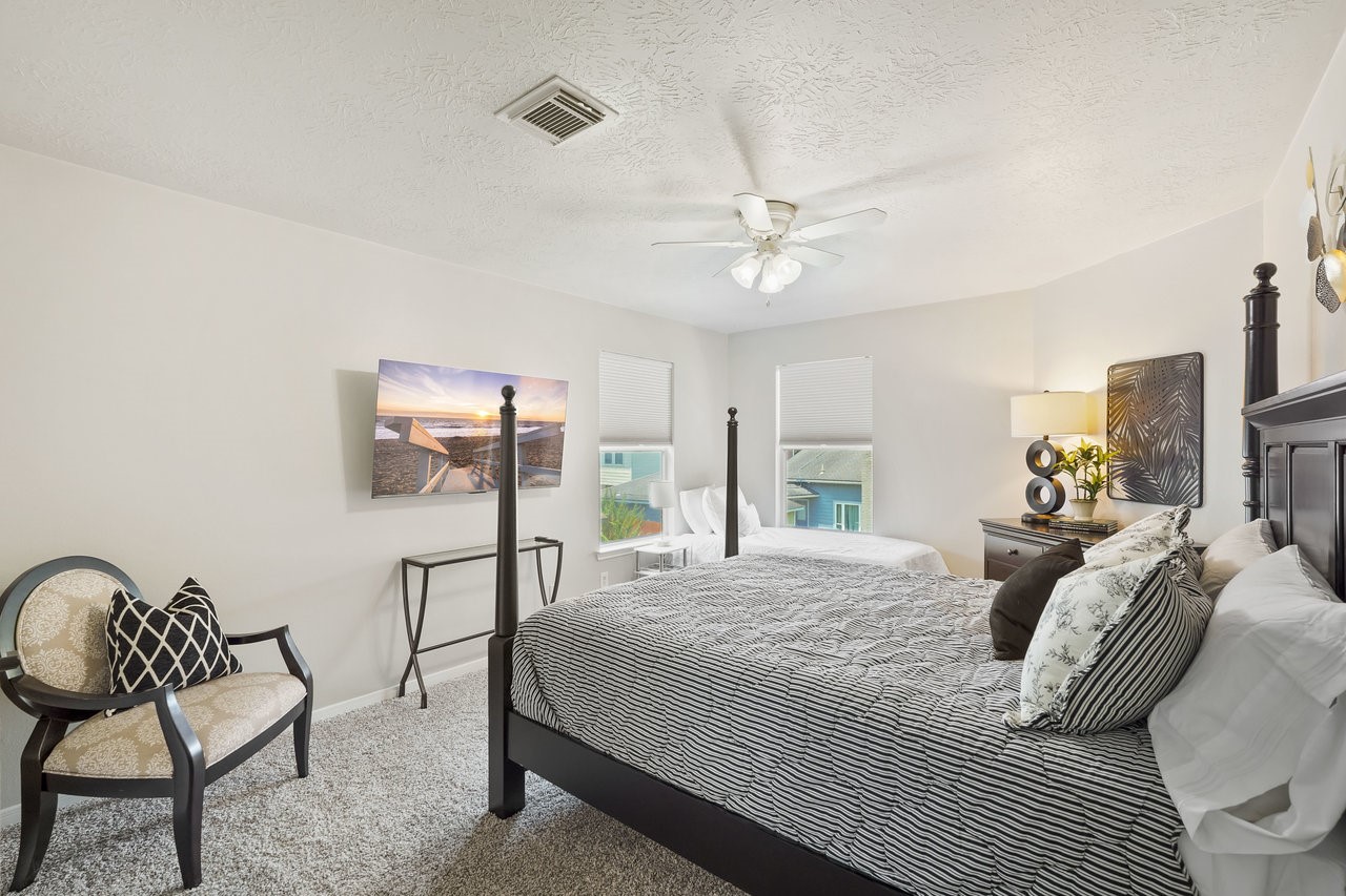 8615 Discus Drive Humble, TX 77346 - Photo 41 of 50 a bedroom with a bed and a chair