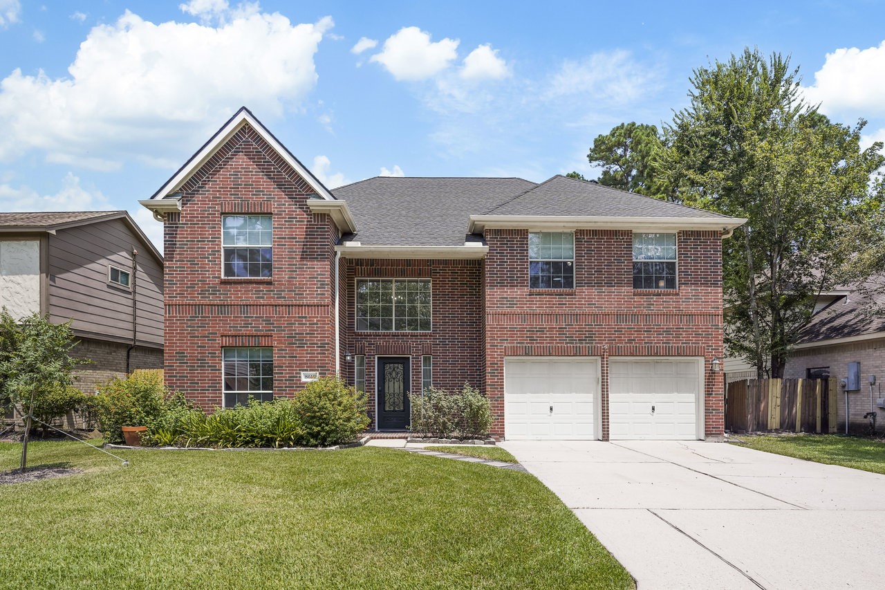 8615 Discus Drive Humble, TX 77346 - Photo 42 of 50 a front view of a house with a yard and garage
