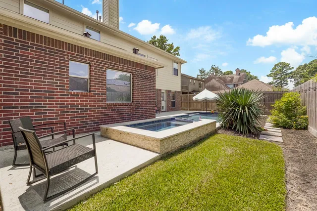 a view of a backyard with plants and a patio