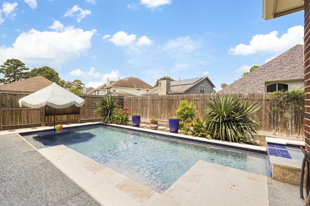 8615 Discus Drive Humble, TX 77346 - Photo 49 of 50 a view of a house with pool and chairs